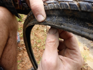Our first blow out made us realise the 26' tire we bought in Chimbote was actually 26.5 and wouldn't fit the wheel so Bren tried sewing up the hole.